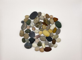 Sea stones on a white background. Lots of sea pebbles