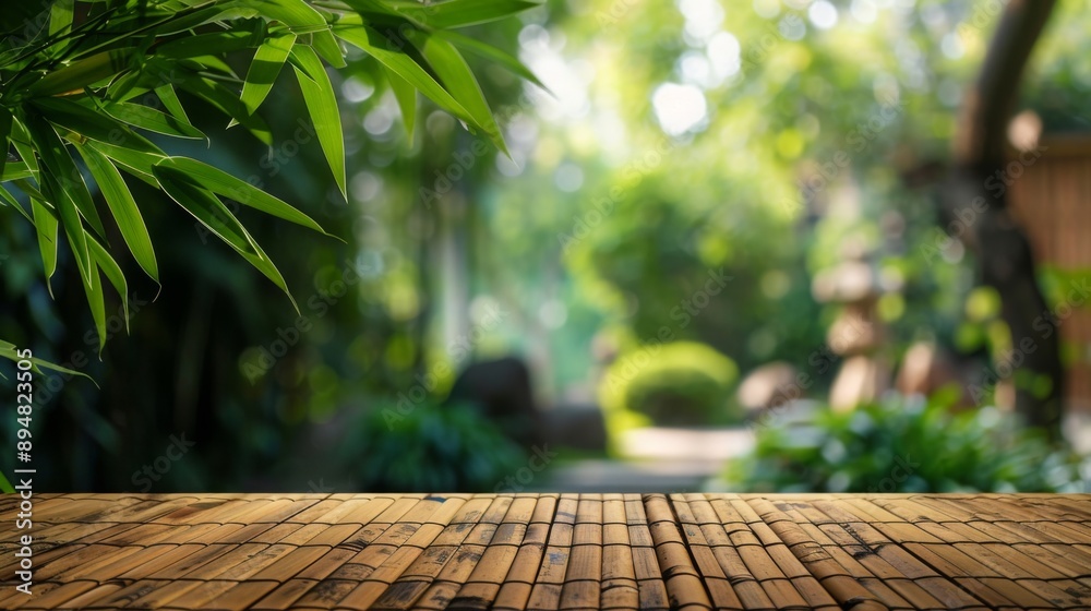 Poster a bamboo tabletop sits in front of a lush, green garden. the background is out of focus, creating a 