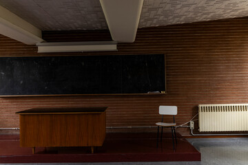 Compulsory school. University, academy, high school. Back to school. Old class, vintage love. Classroom with desk and ancient dirty blackboard, chalk, eraser. Lesson, questions, anxiety about exams. 