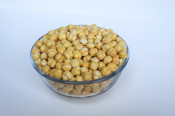 Chickpeas in glass transparent bowl, isolated on white background