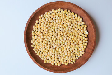 Chickpeas in wooden plate, isolated on white background, flat lay or top view