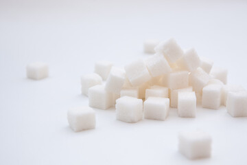 White sugar cubes on white background, sweet food ingredient and spices