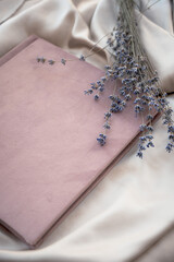 pink wedding or family photo album, lavender, on a light background. flat lay, top view