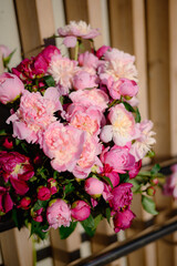 Floral spring background. Pink peonies and petals.