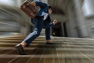 Businessman with briefcase stepping up the stairs quickly for get fund and loan, Busy man is in a...