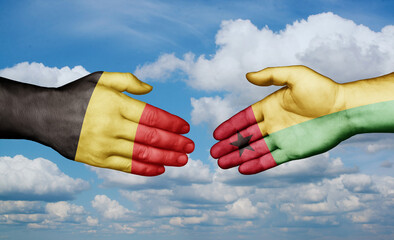 Guinea-Bissau and Belgium country handshaking with flags, consensus concept international co-operation illustration