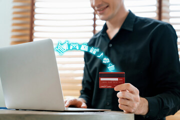 Elegant customer hold credit card with hologram interface choose online platform. Smart consumer typing laptop while open e-commerce application use cashless technology shopping inventory. Cybercash.