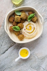 Serving tray with falafel and hummus, vertical shot on a grey granite background, flat lay
