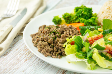 Healthy Plate with Ground Beef, Brown Rice, Vegetables, and Fresh Salad