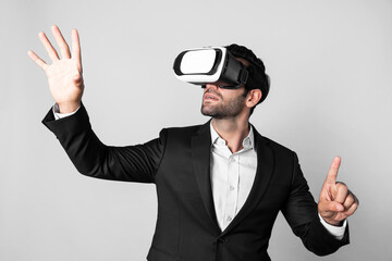 Skilled business man looking at data analysis while wearing VR glasses and suit. Project manager checking and choosing while using visual reality goggles or headset. Innovation technology. Deviation.