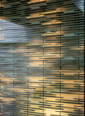 Abstract Reflections of Light on Teal Shelves Through a Window.