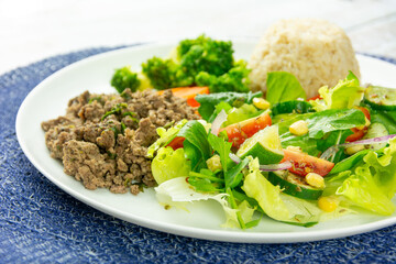 Healthy Plate with Ground Beef, Brown Rice, Vegetables, and Fresh Salad