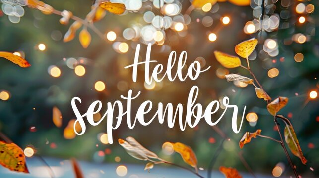 Text "Hello september" on autumn blurred bokeh background 