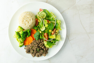 Healthy Plate with Ground Beef, Brown Rice, Vegetables, and Fresh Salad