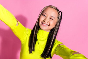 Photo of good mood chinese girl with dyed hairdo dressed yellow turtleneck making selfie winking...