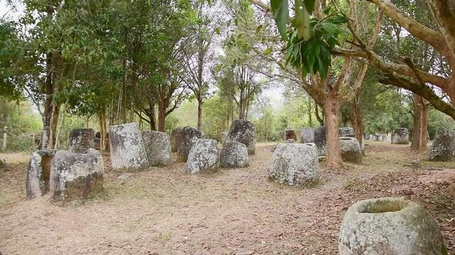 The Plain of Jars site 3.Laos forest. Megalithic archaeological landscape consists of thousands of stone jars scattered around the upland valleys lower foothills central plain - Xiangkhoang Plateau