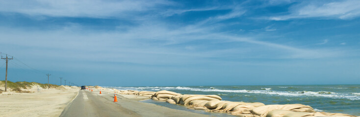 Sand bags line the roadside in North Carolina's Outer Banks, Hatteras Island, USA