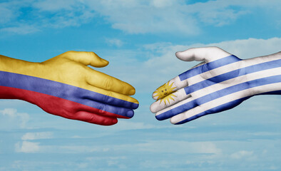 Uruguay and Colombia country handshaking with flags, consensus concept international co-operation illustration