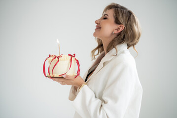 woman celebrate with birthday cake, elegant dressed in white formal suit