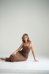 Obraz premium Vogue style woman in long brown slim dress 