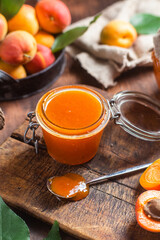 Ripe apricot jam in a jar on the table