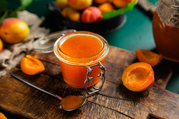 Ripe apricot jam in a jar on the table