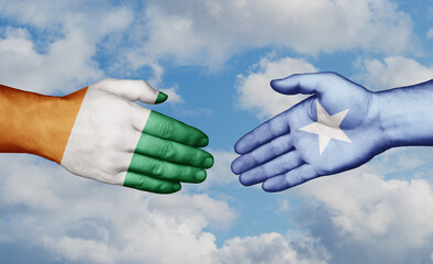 Somalia and Ivory Coast country handshaking with flags, consensus concept international co-operation illustration