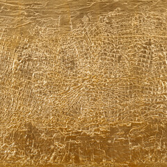 Gold patterned structured background. Golden structural patterns on a golden wall background.