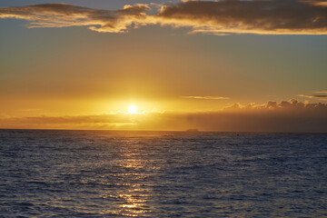 Sunset, sea and horizon of natural environment, beach and ocean during night in summer. Sky, nature and sunrise in landscape for tropical, calm and destination with island peace on Waikiki, Honolulu