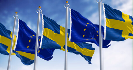 Sweden and the European Union flags waving together on a clear day