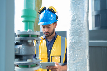 Technician Operating Control Panel in Industrial Setting