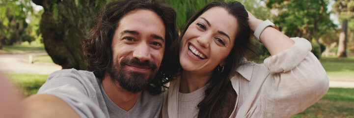 Close-up of couple in love taking selfie on mobile phone, panorama