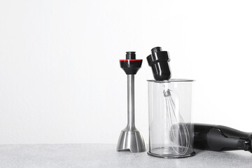 Hand blender kit on gray table against white background, space for text