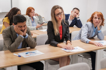 Group of businesspeople with tired faces after hours of company-specific training