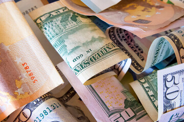 Mixed Currency. Euro and Dollar bills, various denominations visible.