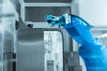 Chemotherapy drug compounding robot with syringe and medicine bottle.Hihg technology pharmaceutical production vaccine concept.New innovation.