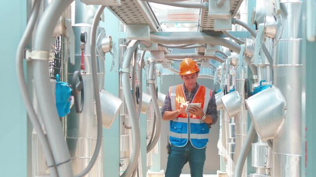 Engineer under checking the industry chilled water fan coil unit air conditioner is water cooling tower air chiller HVAC system of large industrial building to control air systemengineering, construct