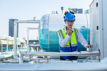 Engineer under industrial inspection Large water heaters are used in high-rise condominiums.