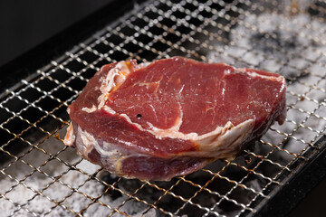 Raw Steak on Barbecue Grill Grate