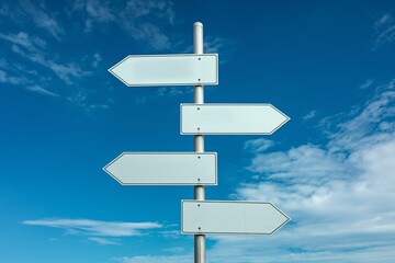 An image of four blank white road signs pointing in different directions against a background of a bright blue sky with scattered clouds.