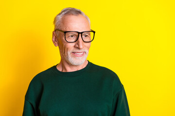 Photo portrait of nice senior man look empty space dressed stylish green clothes isolated on yellow color background