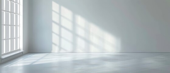 Fototapeta premium A large, empty room with a window that lets in sunlight. The room is very clean and has a very simple design