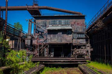 Old industrial buildings covered with plants.