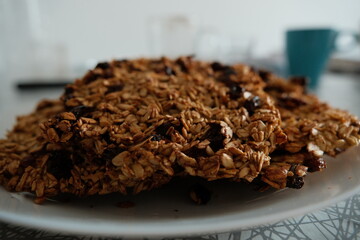 A close-up view of a plate filled with homemade oatmeal cookies, highlighting their texture and wholesome ingredients