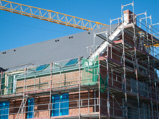 Scaffolding with crane boom