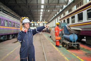 Industrial Technician Using Laptop at Machinery