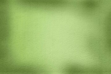 A soft green background with a textured surface and subtle shadows.