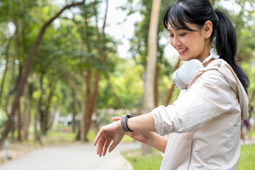 Healthy woman checking smart watch.