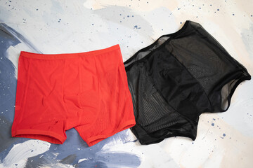 men's sexy transparent red and black panties with mesh sheer textile, male boxer panty lingerie closeup, gay and queer lgbt accessory