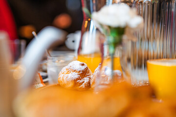Sweet pastries sprinkled with powdered sugar. Lunch table. Restaurant meal menu.